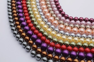 Macro view of multi-colored round glass pearl beads with polished high-gloss finish
