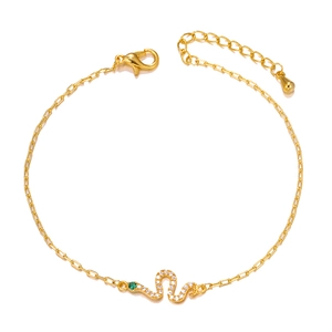 Detail of gold-plated snake pendant featuring white cubic zirconia and green eye stone