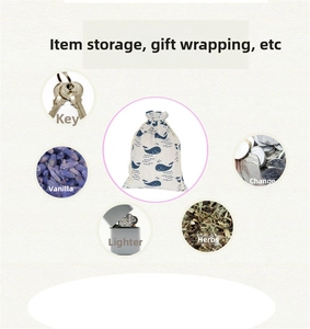 Detail view of cotton drawstring pouch with whale print showing various storage uses