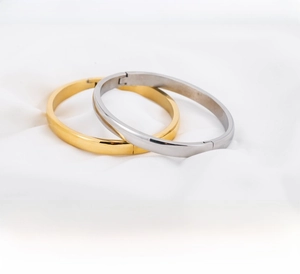 Close-up of 6mm polished stainless steel dome bangles in gold and silver finishes