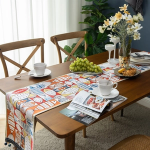 Chenille table runner with colorful fish patterns and blue tassels for New Year decor