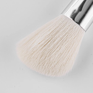 Close-up of dense white bristles and polished silver metal ferrule on the contour brush