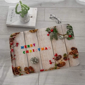 Detail view of a Christmas flannel mat with wood grain patterns and pine cone decorations