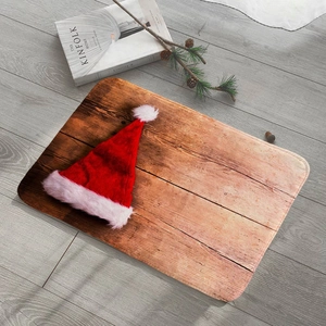 Close-up of red flannel Christmas hat with white plush trim on a wood grain mat