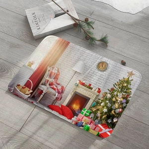 Close-up of Christmas flannel mat with festive fireplace and tree pattern on wood floor