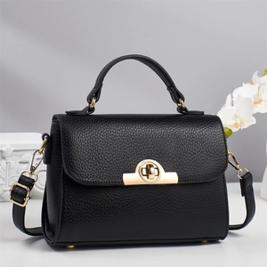 Elegant black lychee leather handbag with gold hardware and adjustable crossbody strap