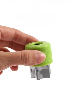 Close-up of star-shaped stainless steel vegetable cutter with green plastic handle