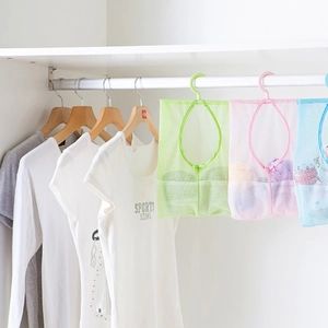 Three-color portable mesh storage bags hanging in a closet for bathroom and kitchen use