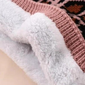 Close-up of pink leopard knit fabric with soft white fleece lining for winter warmth