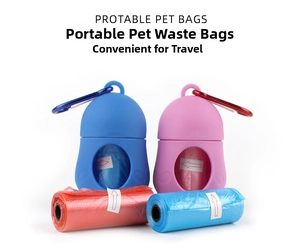 Close-up of portable pet waste bag dispensers with metal carabiners and refill rolls