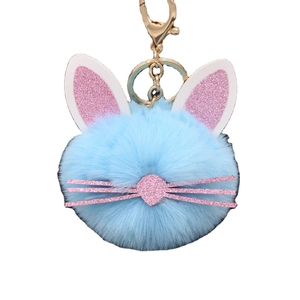 Cute blue plush cat keychain with pink glitter ears and gold metal hardware for bags