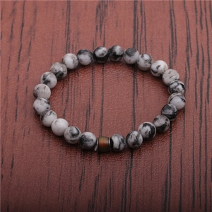 Detailed view of temperature-sensitive beads and white marble stone stretch bracelet