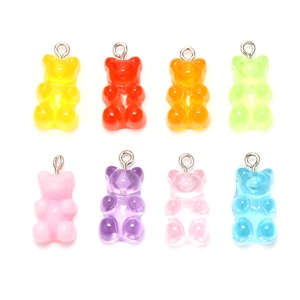 Detailed view of eight colorful translucent resin gummy bear charms for DIY jewelry making