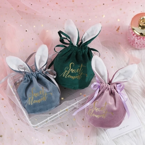 Three velvet rabbit ear gift bags in green, blue, and purple with Sweet Moment gold print