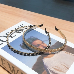 Elegant metal chain and leather headband set with rhinestones on a fashion magazine