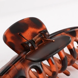 Macro shot of large tortoiseshell plastic hair claw clip with spring and grip teeth