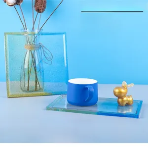 Finished square and rectangular resin coasters with blue gradient and gold glitter details