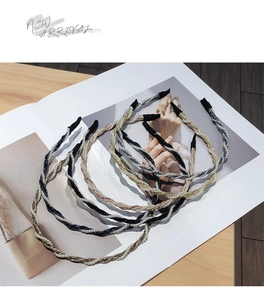Flat lay of multiple pearl braided headbands in gold and silver on a fashion magazine