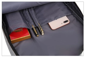 Internal organizer detail of grey laptop backpack showing pen holders and phone compartment