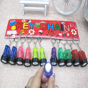 Close-up of colorful LED flashlight keychains in various transparent plastic shells
