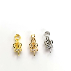 Macro view of micro-paved crown jewelry clasps in gold and silver for pearl pendants