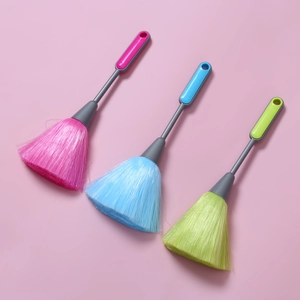 Detailed view of three colorful keyboard cleaning brushes in pink, blue and lime green