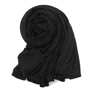 Detail shot of soft black mercerized cotton hijab with elegant spiral folding texture