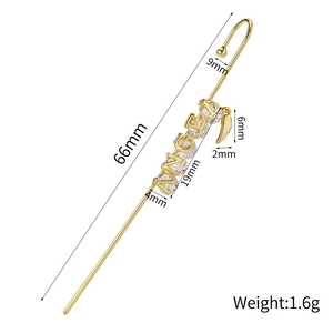 Detail view of 66mm gold ear cuff featuring ANGEL lettering, zircon studs, and feather pendant