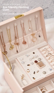 Pink three-layer jewelry box detail showing necklace hooks and soft velvet interior