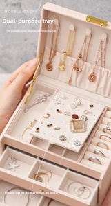Detail of pink jewelry box featuring a multi-purpose board holding 36 pairs of earrings