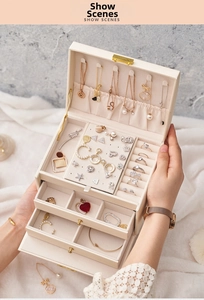 Detailed interior of a three-layer jewelry box with necklace hooks and ring slots