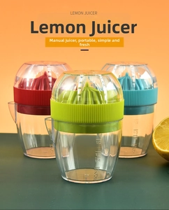 Close-up of manual lemon juicer with colorful squeeze heads and volume scale markings
