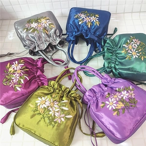 Group shot of colorful satin bucket bags with exquisite floral ribbon embroidery detail