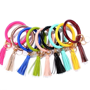 Flat lay of colorful tassel wristlet keychains with wooden beads and silicone rings