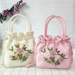 Floral embroidered satin drawstring handbag in white and pink with delicate ribbon flowers