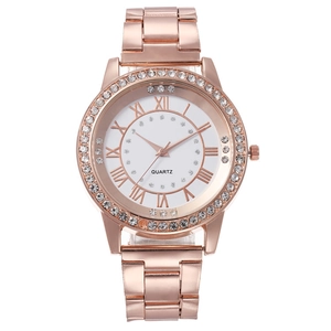 Detail of rose gold barrel watch dial with Roman numerals and rhinestone accents