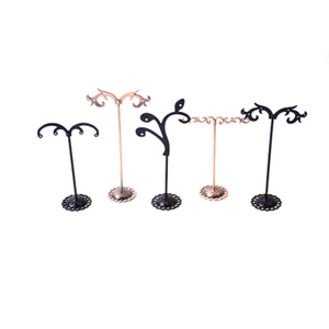 Detail view of five metal earring organizers in black and rose gold finish with scroll design