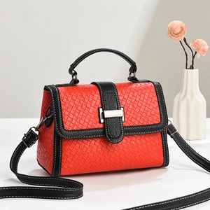 Elegant red woven handbag with black leather trim and silver metal buckle on white background