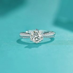 Detailed macro view of a six-prong crown ring with brilliant round zircon and side stones
