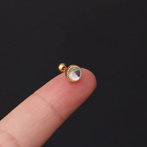 Macro shot of gold stainless steel stud earring with iridescent round opal and screw back