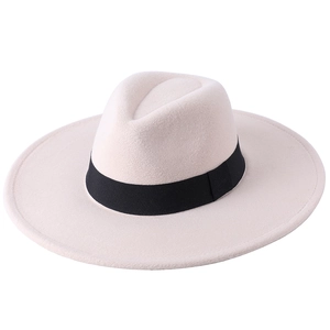 Close-up of beige wool felt fedora hat featuring a wide brim and classic black ribbon trim