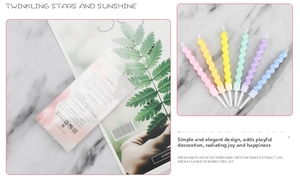 Macro detail of colorful spiral macaron birthday candles with white plastic holders