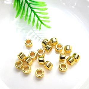 Polished 14k gold-filled spacer beads for DIY jewelry making on white background