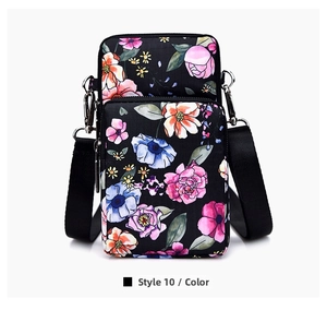 Detail of floral mini crossbody bag with multi-layer zippers and adjustable strap
