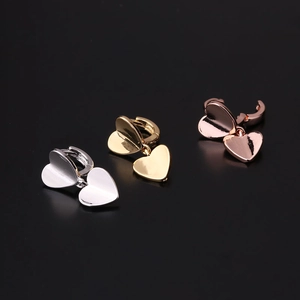 Detailed view of heart shaped hoop earrings in silver, gold, and rose gold finishes