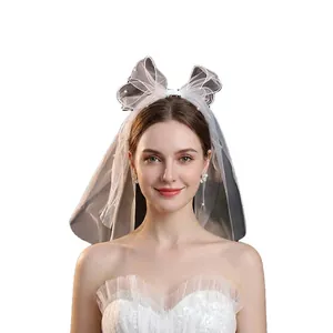 Elegant bridal hair ribbon with white pearls and large bow veil for wedding styling