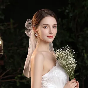 White bridal short veil with delicate pearls and lace embroidery for wedding styling