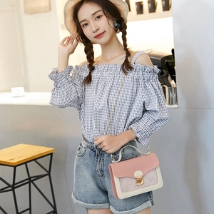 Chic pink and beige crossbody bag with gold lock and chain strap on female model