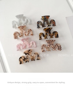 Detail showing seven acetate claw clips with marble and checkerboard patterns