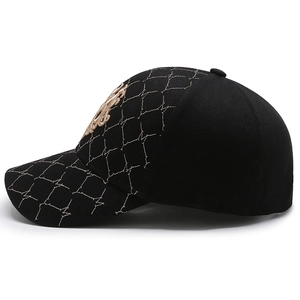 Chic black baseball cap with grid quilting and gold embroidery, structured firm top